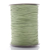 A spool of light green waxed cotton cord used for jewelry making
