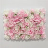 A wall panel covered in pink and white silk rose flowers for weddings and events.