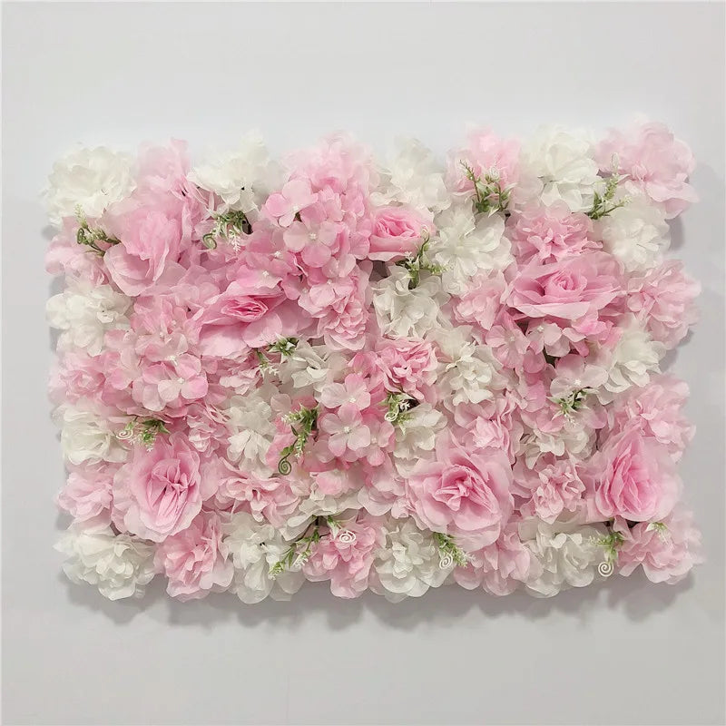 A wall panel covered in pink and white silk rose flowers for weddings and events.