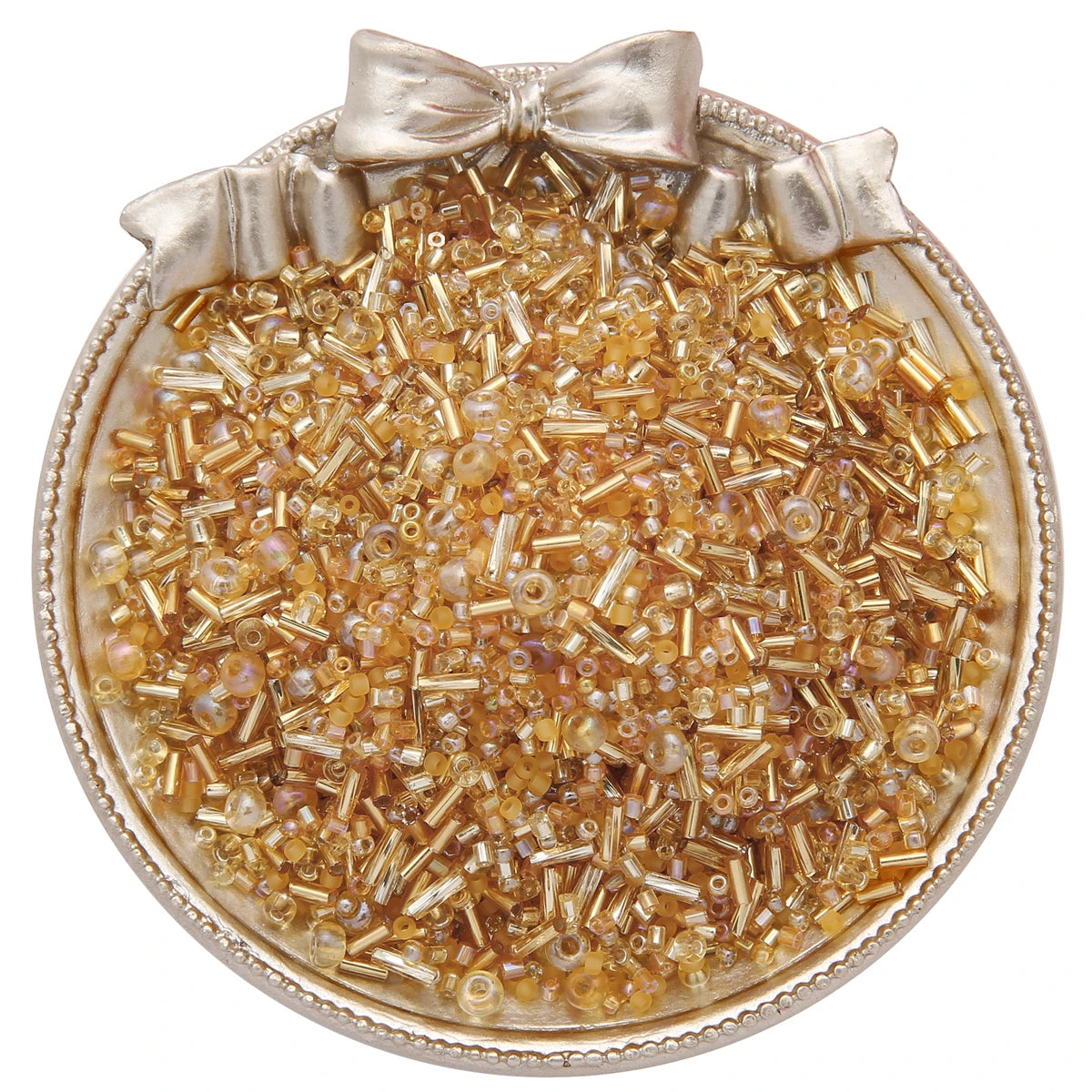 A clear glass seed bead product featuring small amber and gold colored beads arranged in a circular dish with a bow.