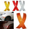 A set of three reflective X-shaped safety stickers in yellow, red, and silver for car fenders.
