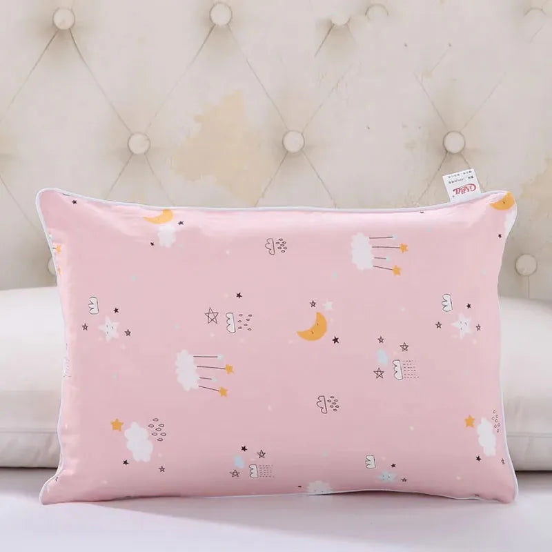 A pink cartoon pillowcase featuring various stars, clouds, and yellow crescent moons for kids.