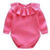 A pink ribbed long-sleeved romper for a baby girl with a ruffled collar