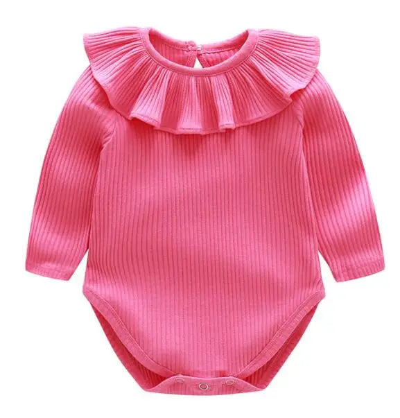 A pink ribbed long-sleeved romper for a baby girl with a ruffled collar