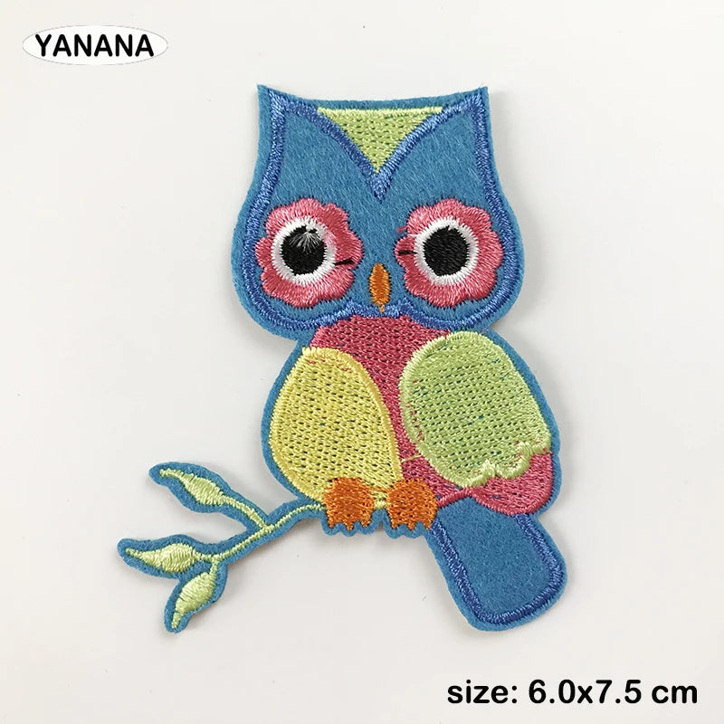 A blue owl embroidered patch with pink and yellow accents for DIY customization.