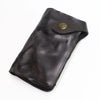 A dark brown vintage cowhide leather bi-fold wallet with a brass-toned clasp.