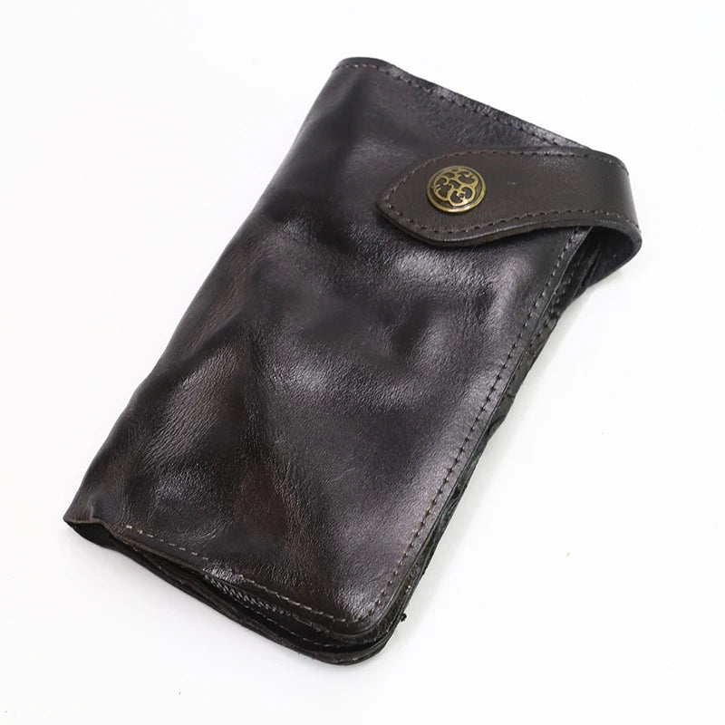 A dark brown vintage cowhide leather bi-fold wallet with a brass-toned clasp.