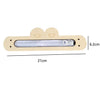 A wooden busy board with a clear plastic strip and a small metal piece, designed for fine motor skills.