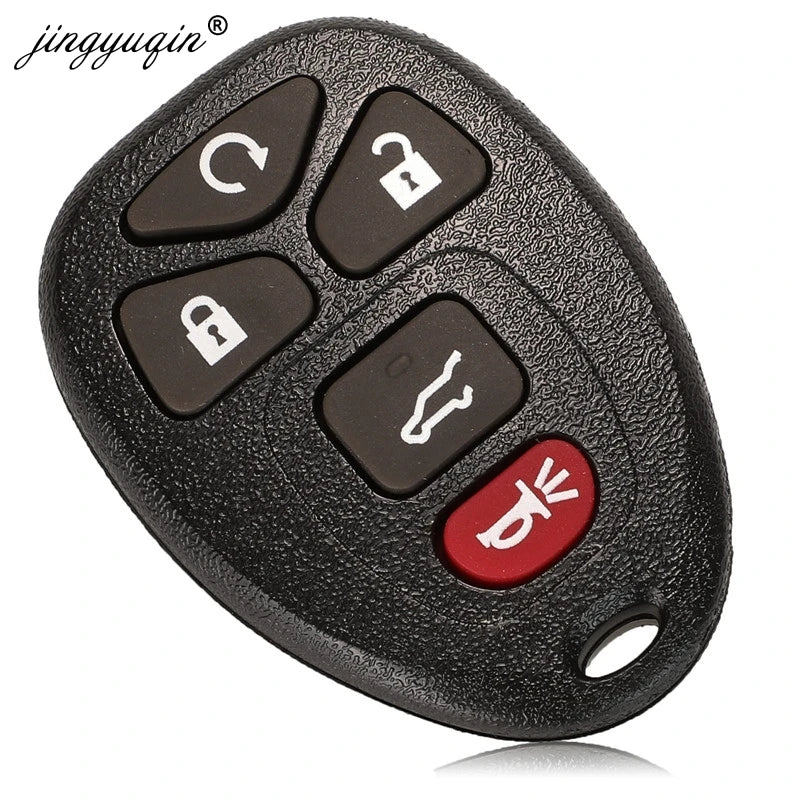 A black replacement car key fob with various buttons and a red key blank is shown.