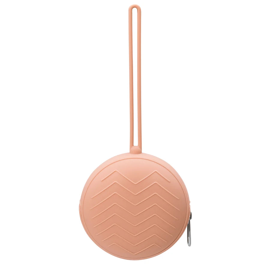 A pink food-grade silicone pacifier case with a ribbed texture.