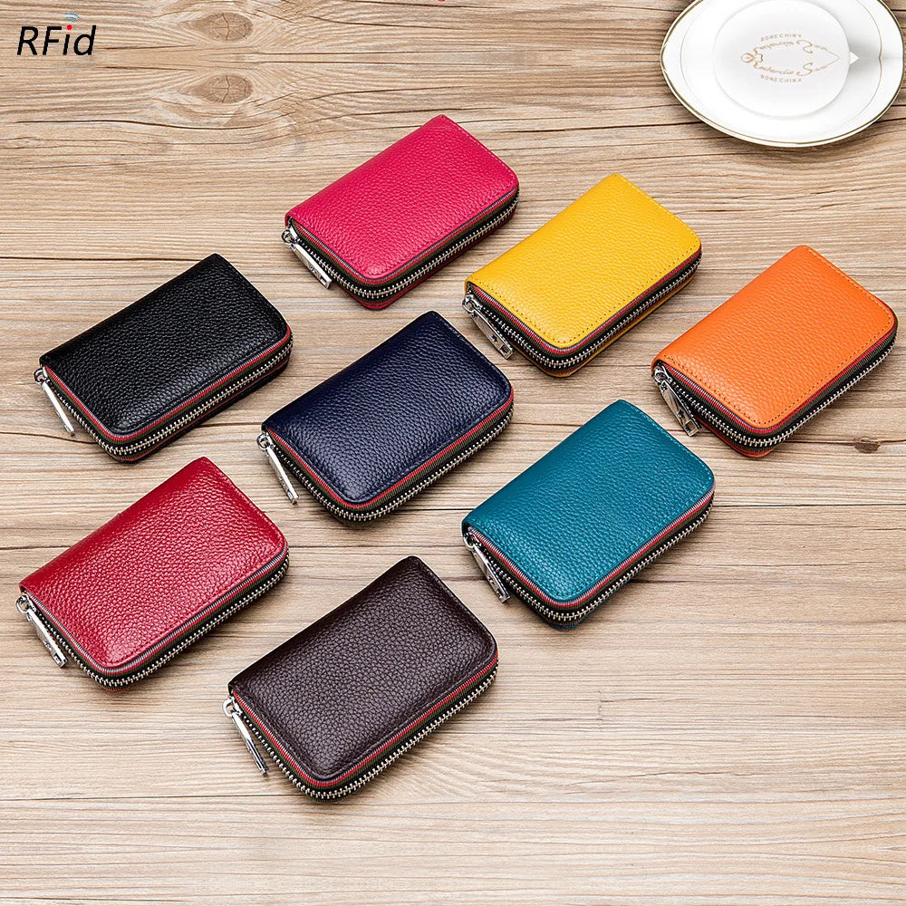 A collection of genuine leather card holders in various colors including red, black, blue, green, and orange, displayed on a 