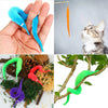 A set of magic trick props including a blue feather, an orange flower, and various colored snakes.
