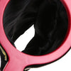 A pink magic trick prop set featuring a black bag and flower inside the opening.