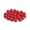 A pile of round, shiny red imitation pearl beads for jewelry making.