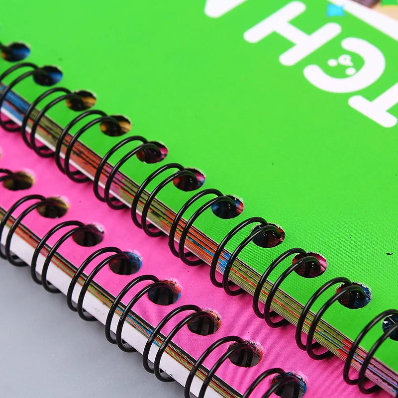 A close-up view of a pink spiral notebook filled with rainbow colored scratch art paper sheets.