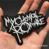 Black embroidered punk skull patches with white text on a hand