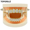 مجموعة أسنان ذهبية صلبة (Grillz)