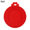 A bright red reusable silicone food storage lid with a handle.