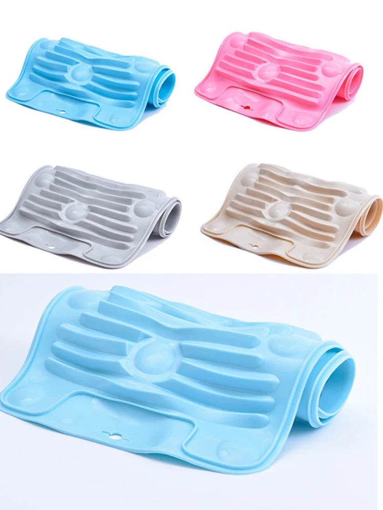 A set of four foldable silicone washboards in blue, pink, gray, and beige with non-slip suction cups.