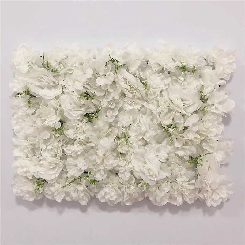 A dense wall panel made of white silk rose flowers for weddings and events.