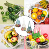 Two organic cotton mesh produce bags filled with fresh fruits and vegetables like bananas, citrus, and leafy greens.