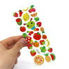 A hand holds a variety pack of 3D puffy stickers featuring various animals and fruits.