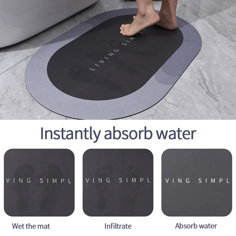 A black bath mat is shown being used to absorb water on a gray tiled floor.