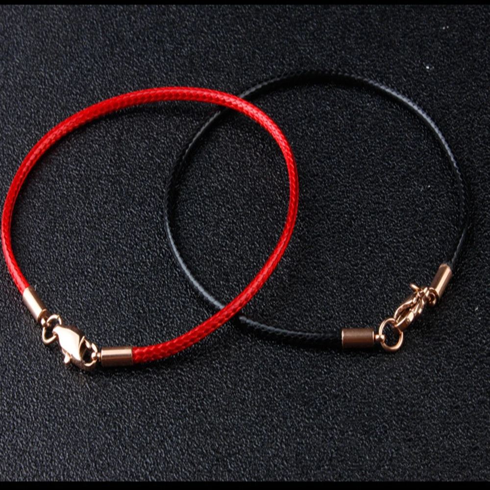A pair of jewelry making bracelets, one red waxed cotton cord and one black cord with gold clasps.