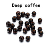 A collection of dark brown, natural wooden spacer beads scattered on a white background.