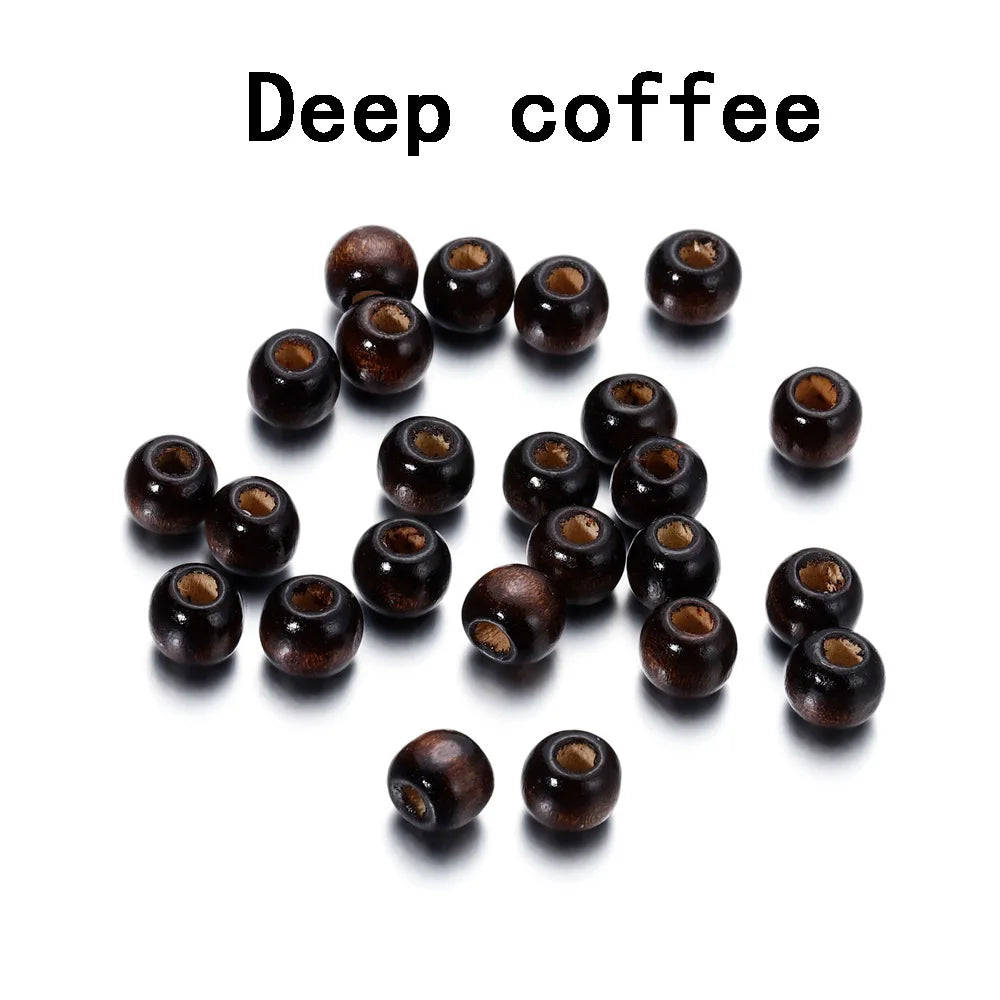 A collection of dark brown, natural wooden spacer beads scattered on a white background.
