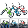A set of three 1/10 scale RC crawler decorations in green, blue, and red, complete with accessories like a shovel, fire extin