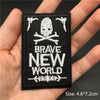 Black embroidered patch featuring a skull and crossed bones with the text BRAVE NEW WORLD