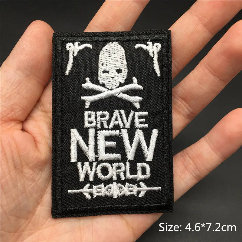 Black embroidered patch featuring a skull and crossed bones with the text BRAVE NEW WORLD