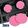 Two pink rhinestone non-slip cup mats for cars are shown in a black organizer tray.