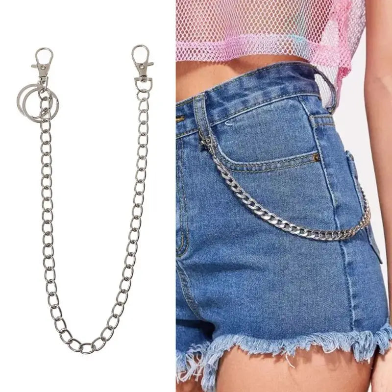 A close-up of a 16-inch chrome steel punk chain belt accessory with a keyring worn on a denim skirt.