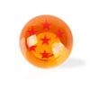 A glossy orange spherical shift knob featuring a star design.