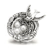 Silver metal snap buttons featuring a bird and three white pearls for jewelry making