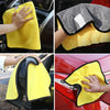 Yellow microfiber car care towel being used to clean a car surface.