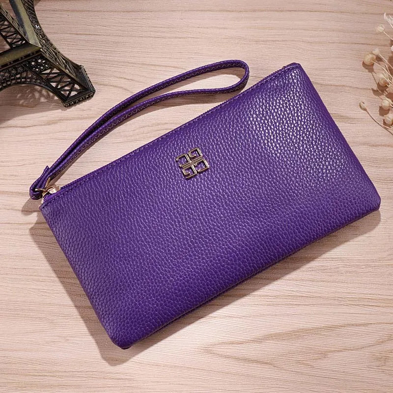 A purple Litchi-Grain PU leather long wallet with a gold logo resting on a wooden surface.