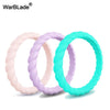 Three braided silicone rings in pink, purple, and teal displayed against a white background.