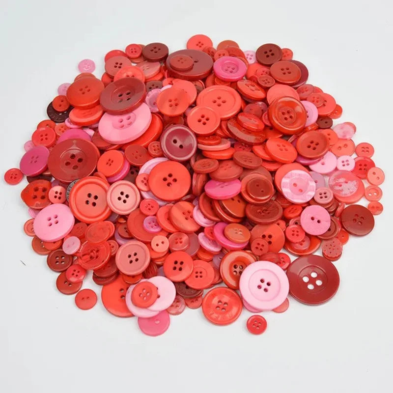 A pile of assorted eco-friendly wooden buttons in shades of pink, coral, and red.