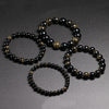 A set of handmade stretch bracelets featuring natural black and gold obsidian gemstones.