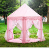 Pink foldable princess tipi play tent set up outdoors on green grass