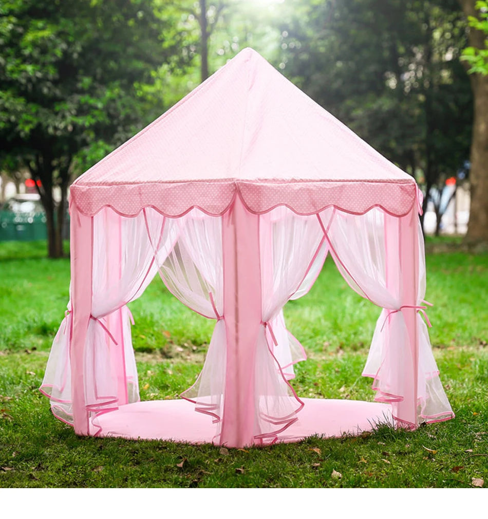 Pink foldable princess tipi play tent set up outdoors on green grass