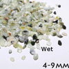 A pile of wet decorative stone pebbles ranging in color from pale green to gray and black, measuring 4-9 mm.