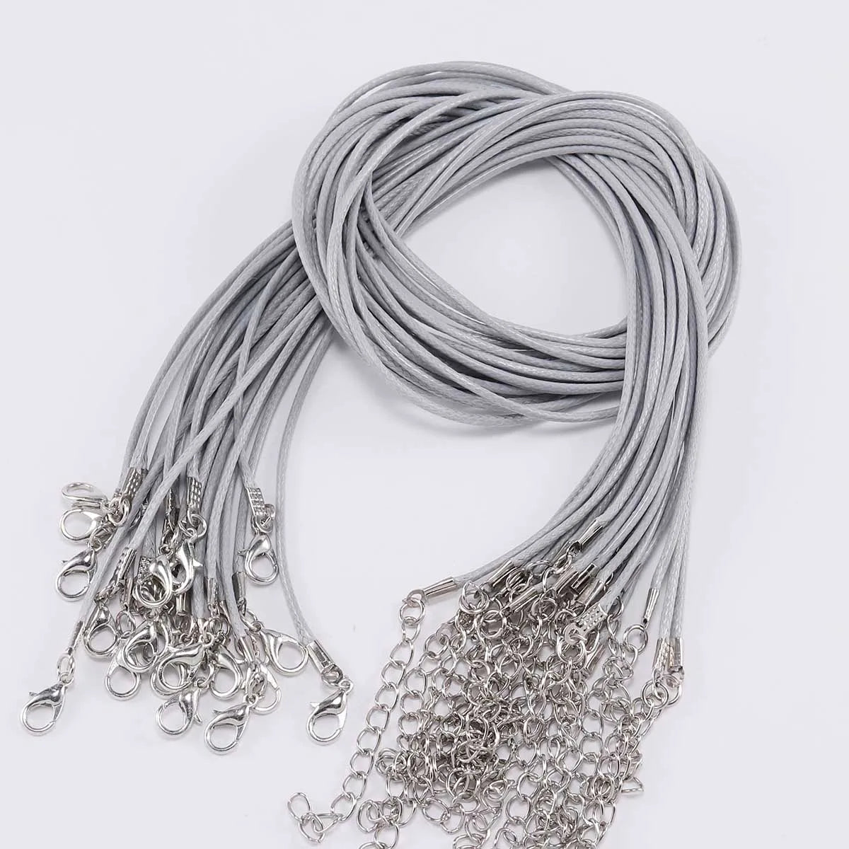 A bundle of silver gray adjustable leather cord necklaces with metal clasps