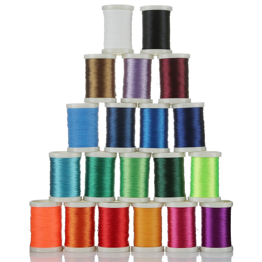 A stack of various colored braided polyester rod wrapping thread spools.