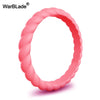 A pink braided silicone ring shown in a close-up view.