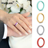 A hand wearing a braided silicone ring against a white background with a floral backdrop.