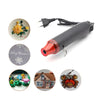 A black heat gun is shown with various decorative Christmas-themed tips and accessories.